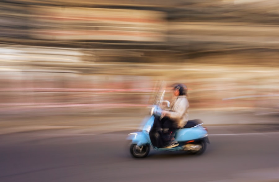 a blurry photo of a person riding a scooter