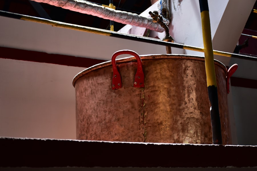A metal bucket sitting on top of a wooden floor