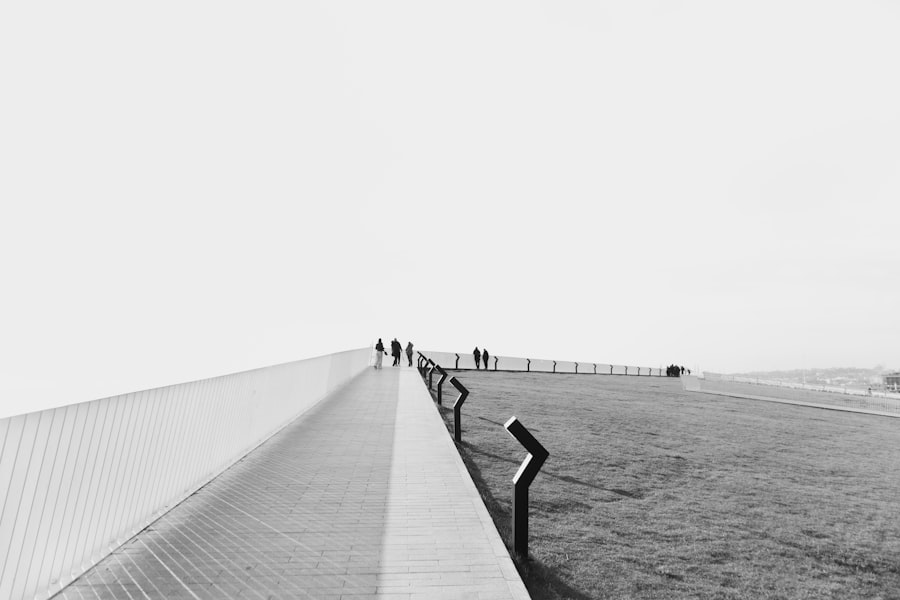 People walking on a modern pathway with grassy area