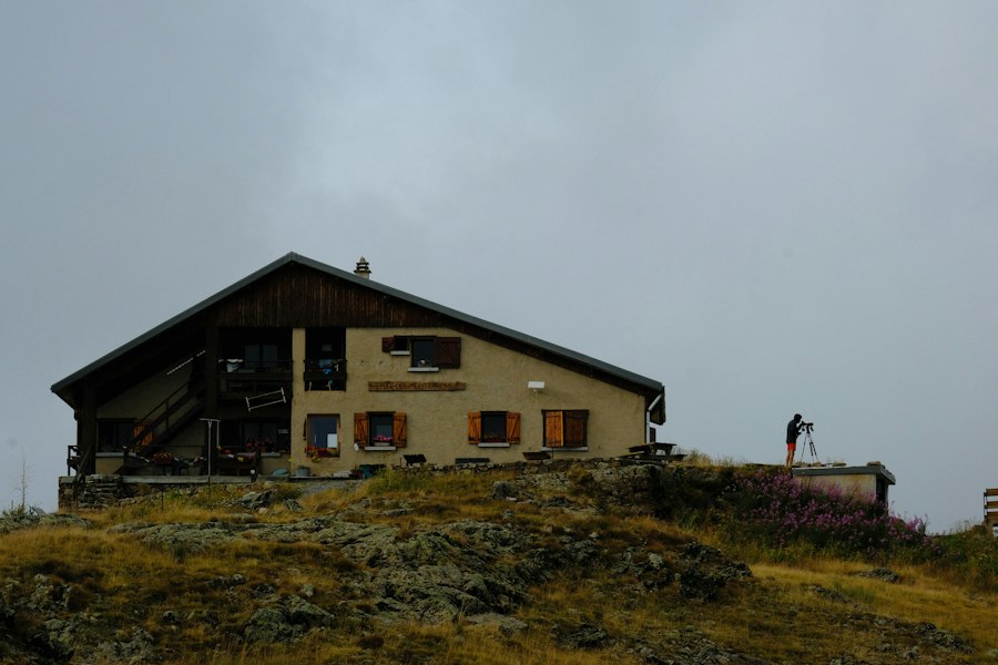 Mountain hut on a hill under an overcast sky